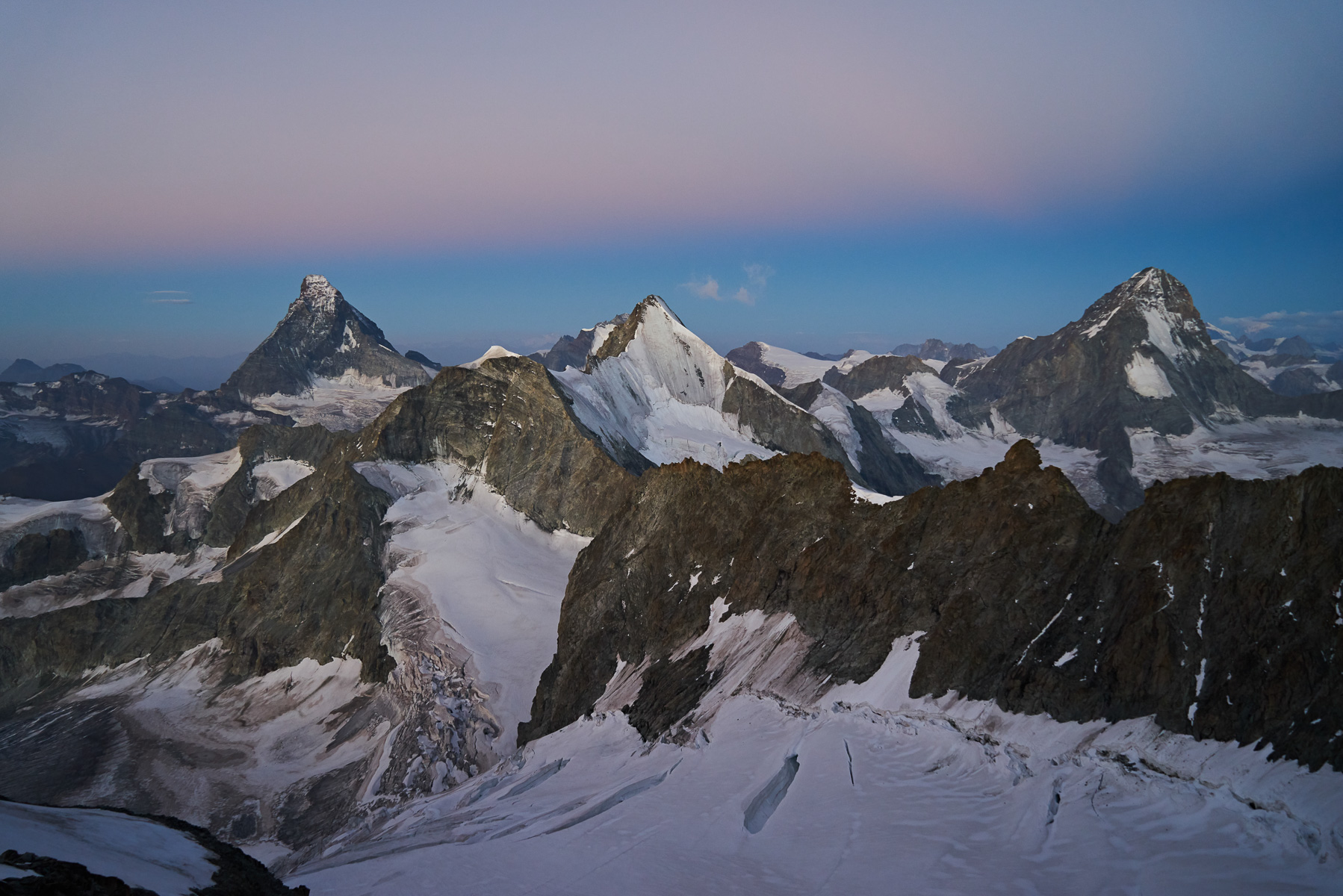 Im Aufstieg zum Zinalrothorn leuchten Matterhorn, Obergabelhorn und Dent Blanche.